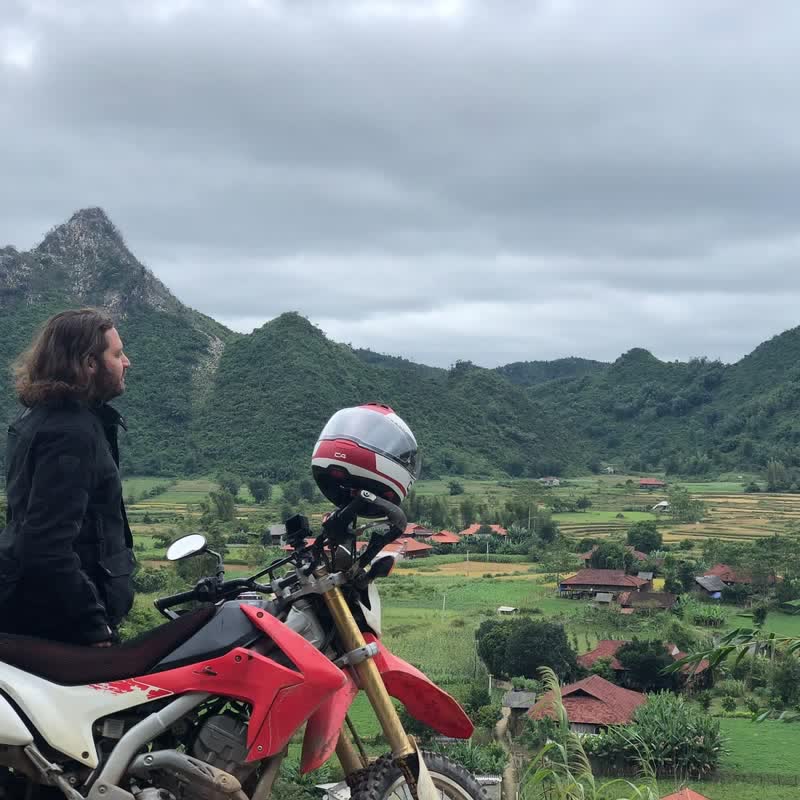 Peter Corbett motorcycling Vietnam mountains during post-CEO ego death spiritual journey